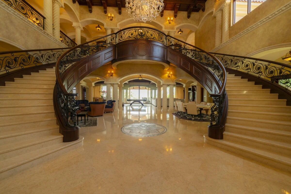 luxury villa interior with grand double staircase chandelier and high ceilings in los suenos
