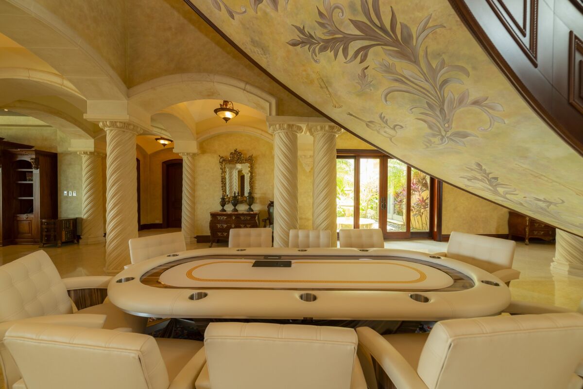 luxury villa game room in los suenos with poker table upholstered chairs and ornate interior details