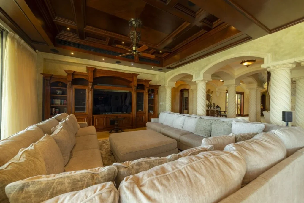 A spacious media lounge designed for gathering, with comfortable seating and refined finishes throughout.