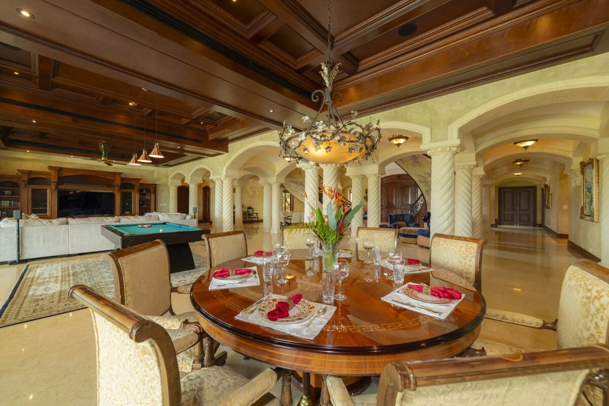 luxury villa dining area in los suenos with round table chandelier billiards table and open living space