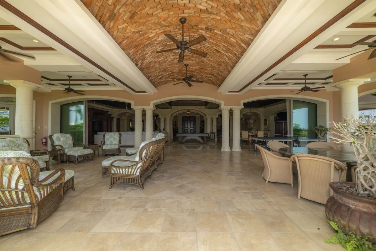 luxury villa covered terrace in los suenos with brick ceiling lounge seating and outdoor dining area