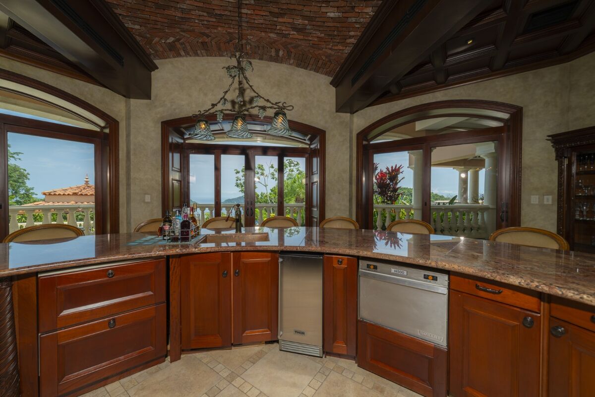 luxury villa kitchen in los suenos with large island ocean view windows and wood cabinetry