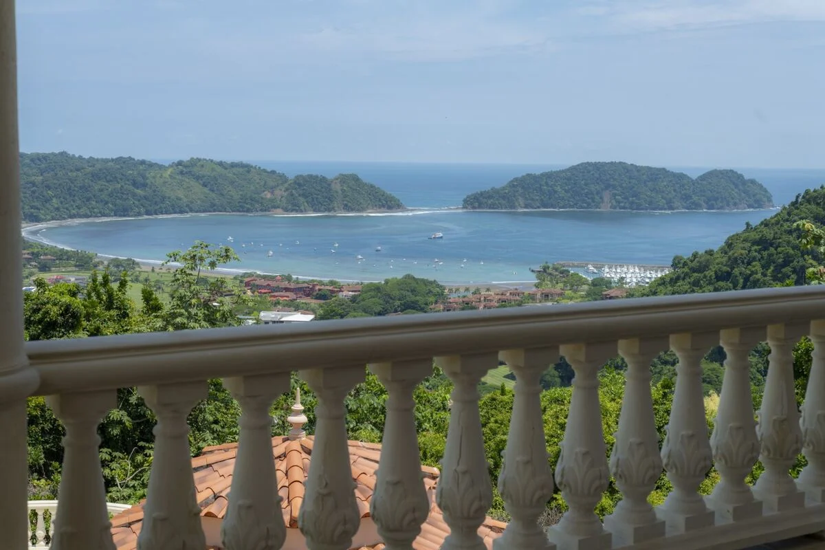 balcony view from luxury villa in los suenos overlooking bay ocean marina and rainforest hills