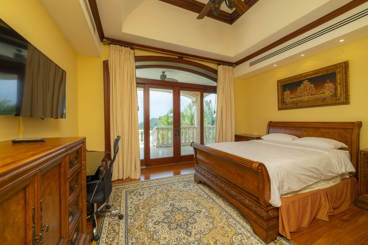 luxury villa bedroom in los suenos with terrace access wood furniture and natural light