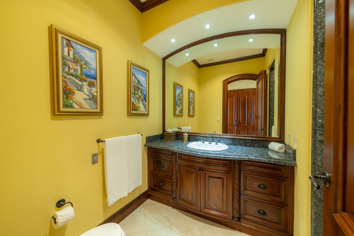 luxury villa bathroom in los suenos with granite countertop vanity mirror and wood cabinetry