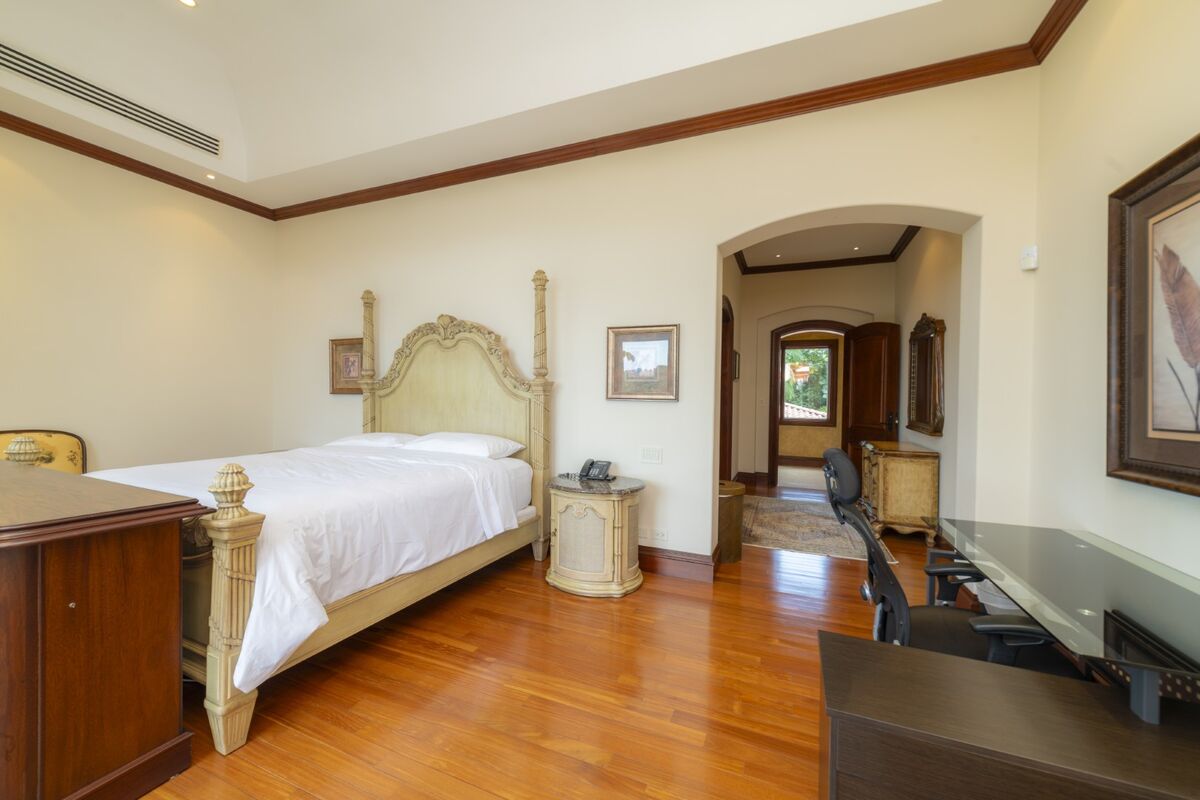 luxury villa bedroom in los suenos with home office desk wood flooring and classic furnishings