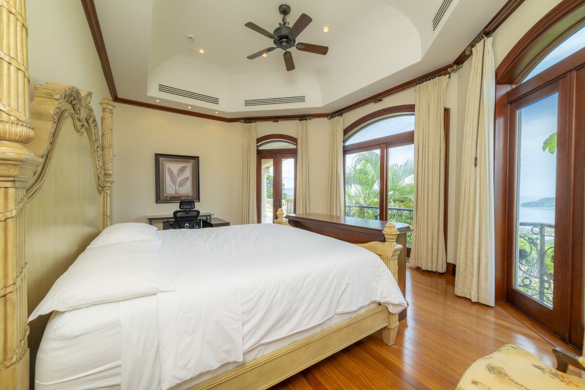 luxury villa bedroom in los suenos with ocean view balcony large windows and wood flooring