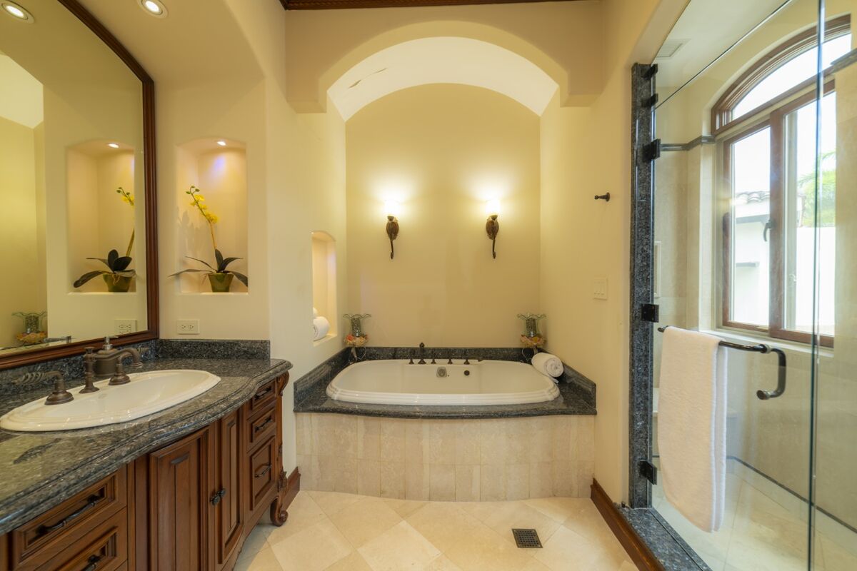 luxury villa bathroom in los suenos with soaking tub granite vanity and glass walk in shower