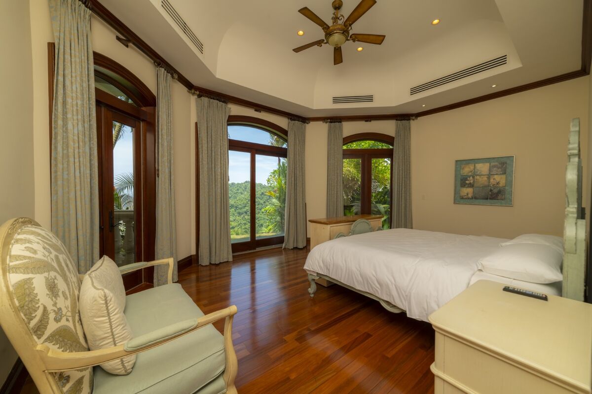 luxury villa bedroom in los suenos with large windows hardwood floors and mountain views