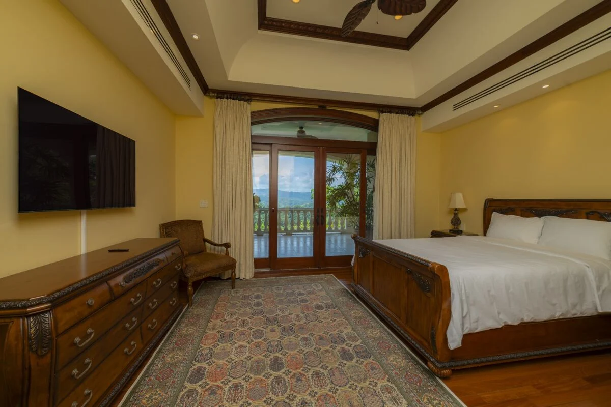 luxury villa bedroom in los suenos with terrace access upholstered headboard and tv