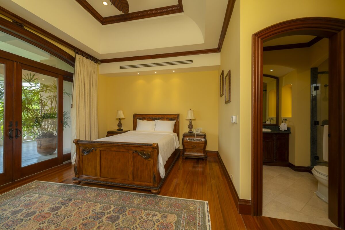 luxury villa bedroom in los suenos with ensuite bathroom wood floors and terrace access