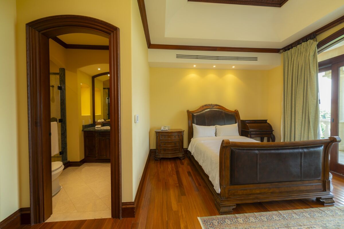 luxury villa bedroom in los suenos with ensuite bathroom wood floors and balcony access