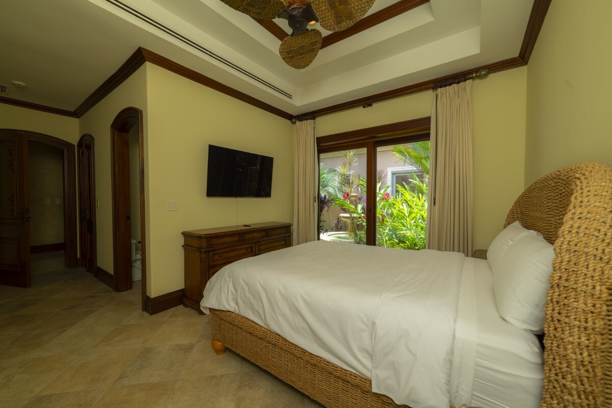 luxury villa bedroom in los suenos with garden view sliding doors and ensuite bathroom