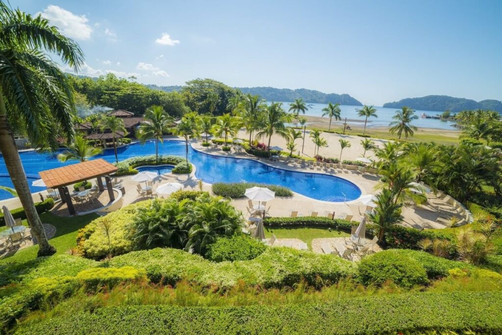 Oceanfront pools at Los Sueños Beach Club, where tropical gardens meet the Pacific.