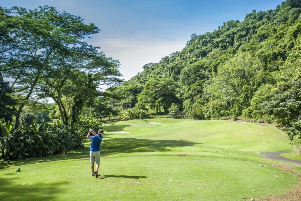 Play along lush tropical fairways surrounded by rainforest at Los Sueños.