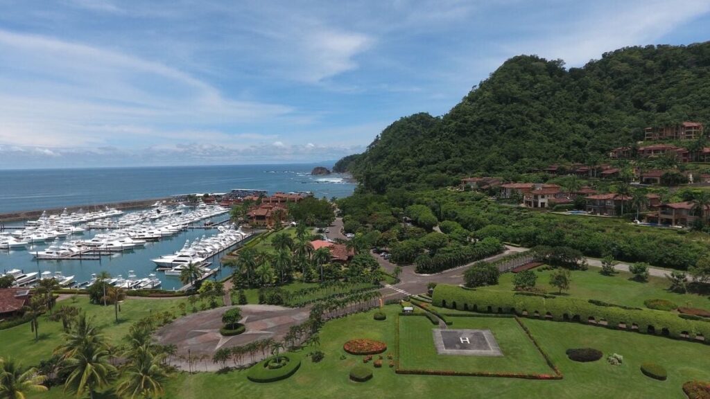 Los Sueños Marina from above, where luxury yachts meet the Pacific coastline.