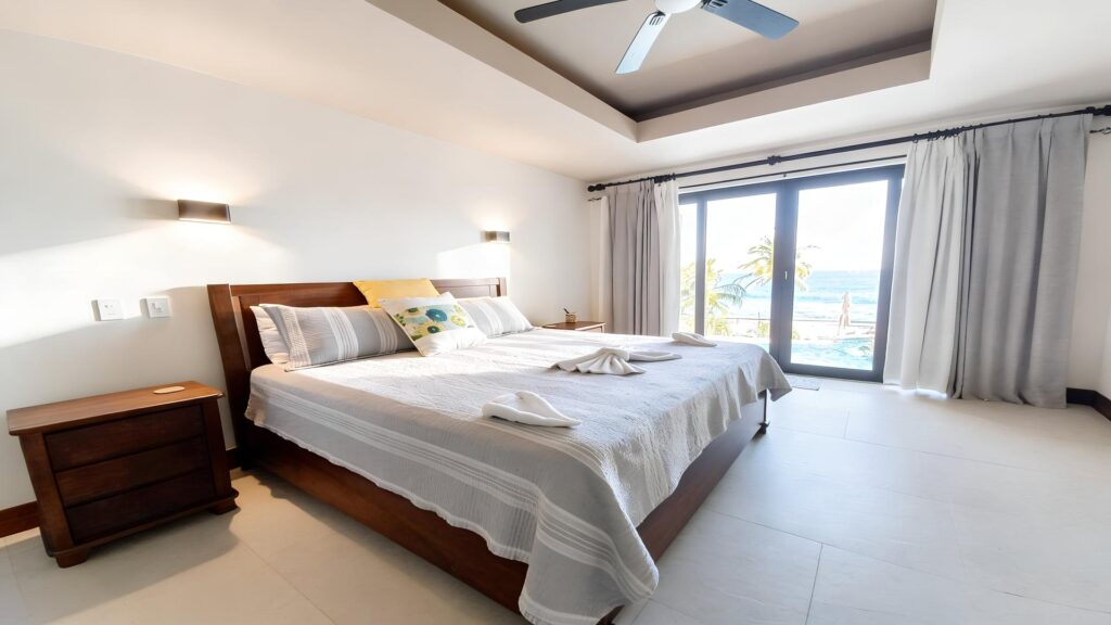 Wake up to panoramic Pacific Ocean views from a spacious primary bedroom with direct access to a private balcony.