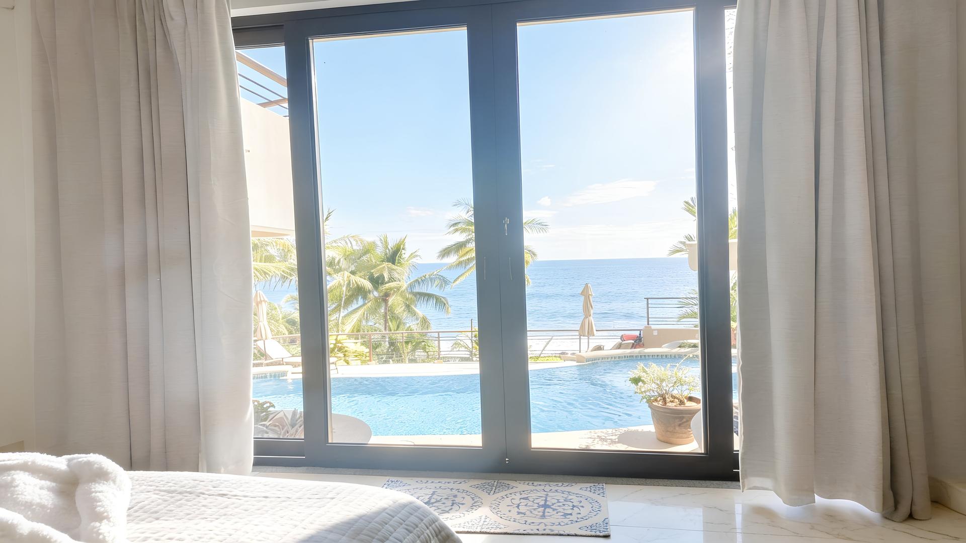 Ocean-view bedroom overlooking the pool and Pacific Ocean in a luxury beachfront vacation villa in Costa Rica