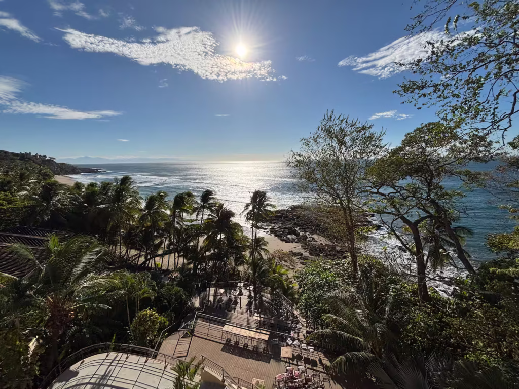 Panoramic views stretch across the Pacific Ocean, tropical coastline, and quiet beachfront from this exceptional oceanfront setting.