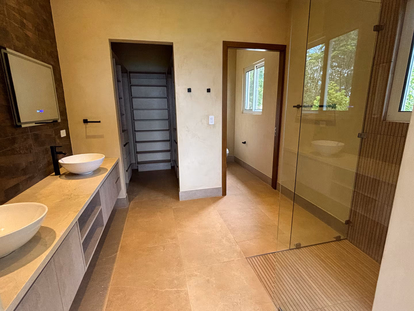 Spacious bathroom with double vanity and walk-in shower in a family vacation villa in Costa Rica