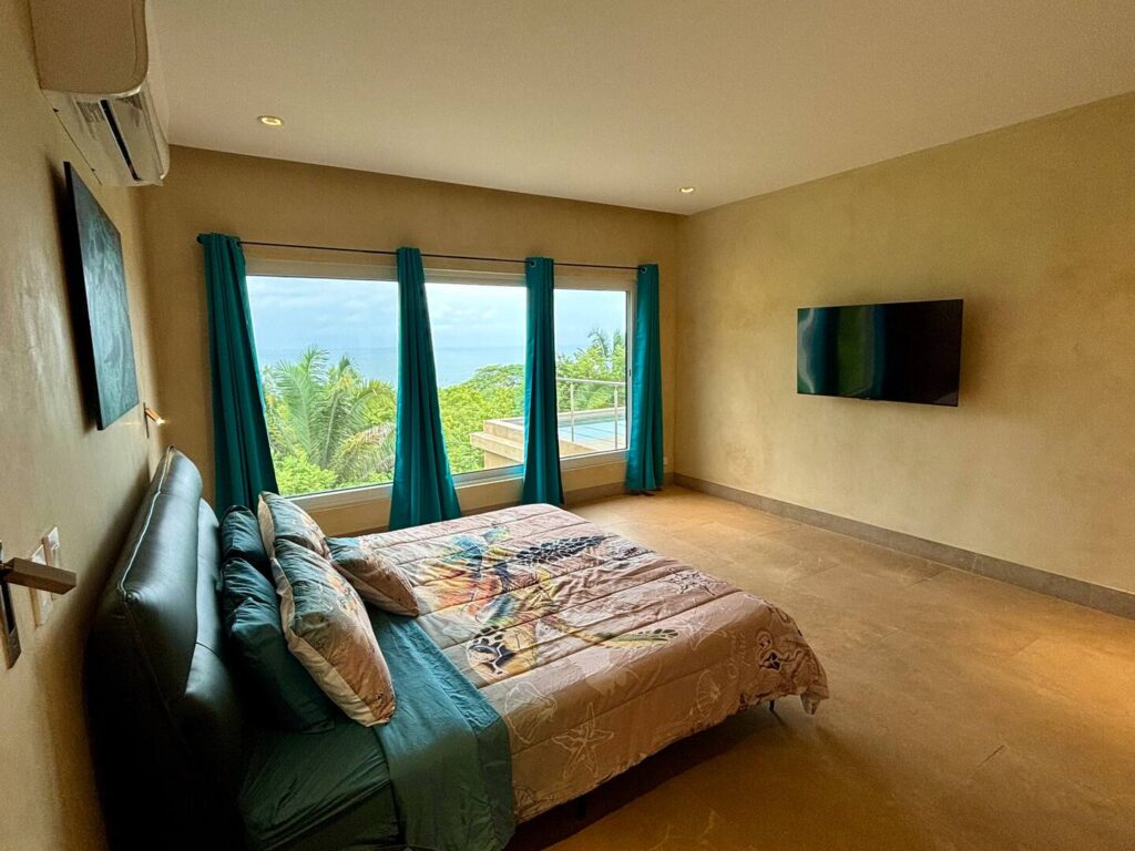 Wake up to tropical scenery and Pacific Ocean views from this bright and comfortable guest bedroom.