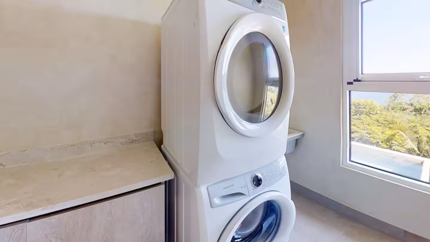 Laundry room with full-size washer and dryer in a Costa Rica vacation villa