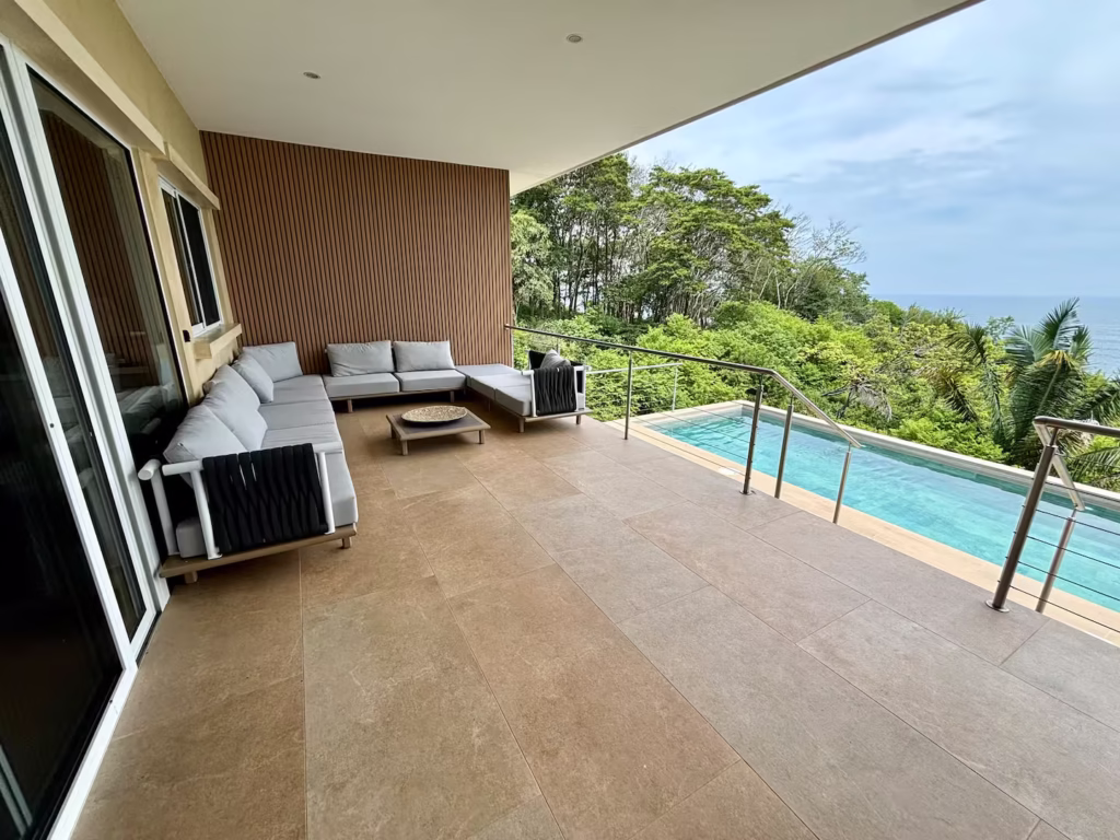 Covered outdoor terrace with private pool and Pacific Ocean views at a family vacation villa in Costa Rica