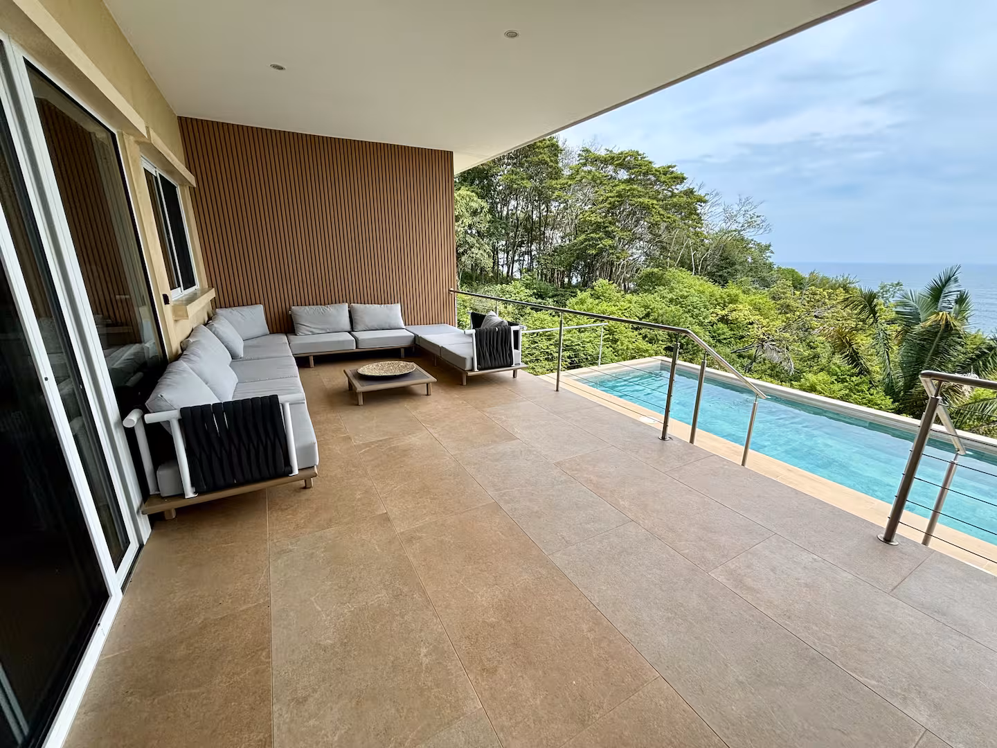 Covered outdoor terrace with private pool and Pacific Ocean views at a family vacation villa in Costa Rica