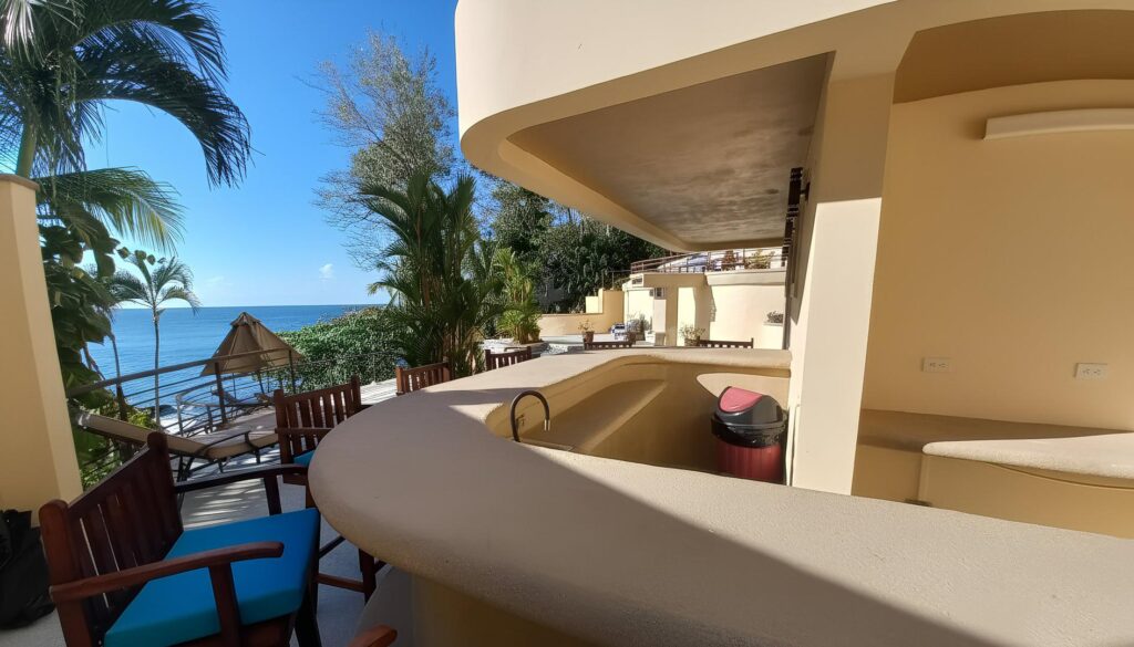 A covered outdoor bar overlooking the Pacific creates the perfect gathering place for sunset cocktails and relaxed evenings by the sea.