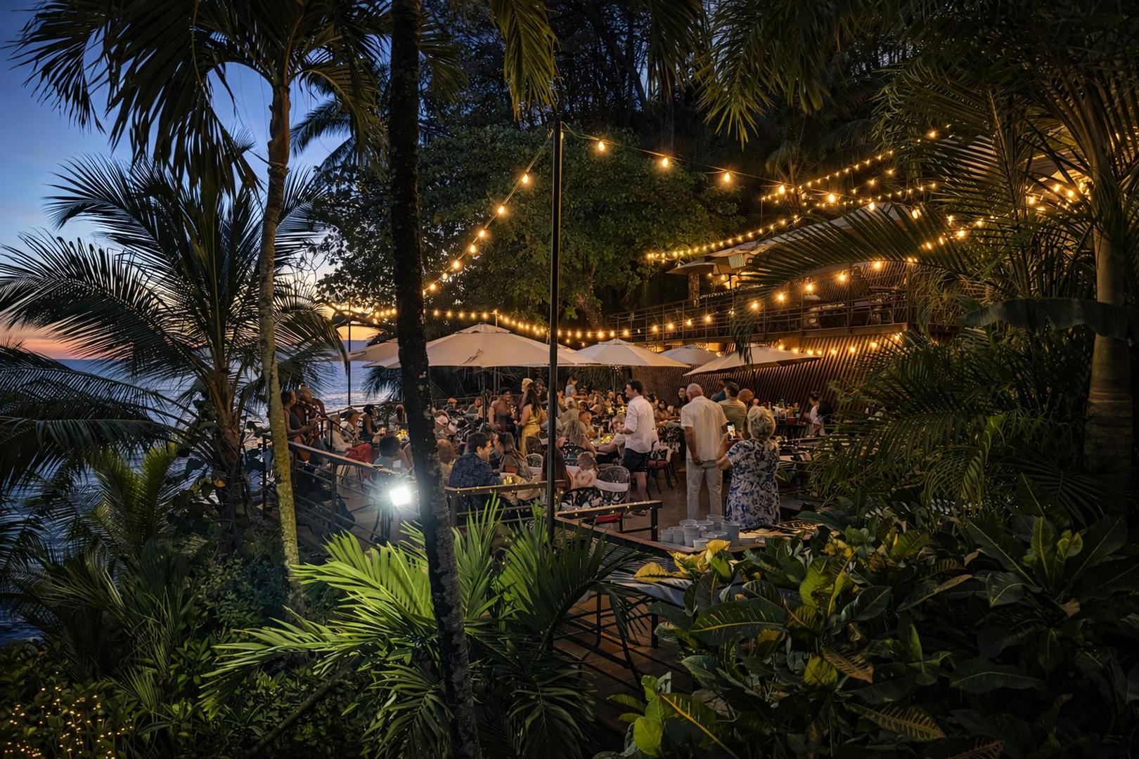 Oceanfront entertainment deck illuminated for a private beachfront dinner in Costa Rica